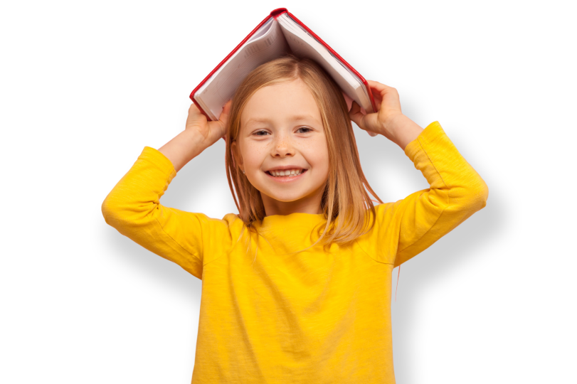 Young girl smiling holding a book over her head