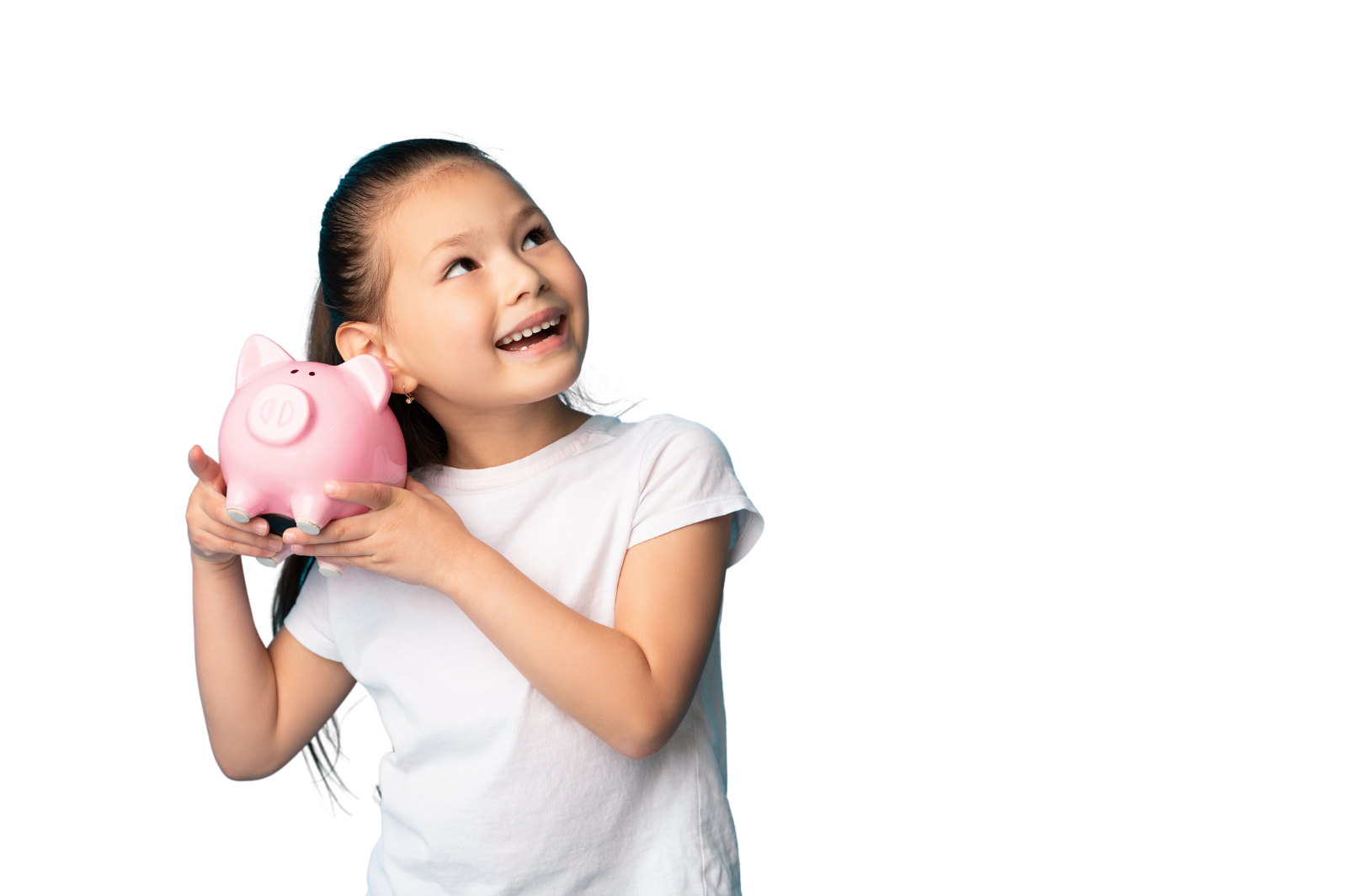 young girl with pink piggy bank shaking it to hear what is inside close to her ear