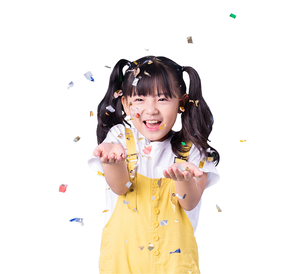 Young girl smiling with confetti falling around her