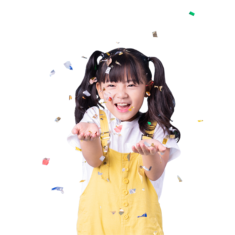 Young girl smiling with confetti falling around her