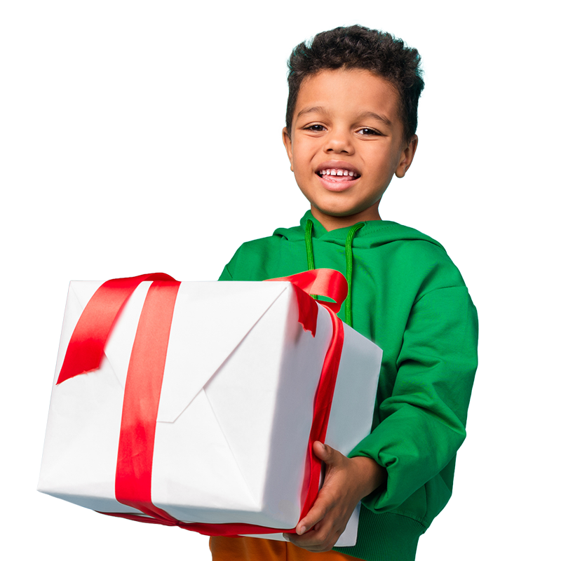 A young boy joyfully holds a large gift box, showcasing excitement and anticipation for what’s inside.