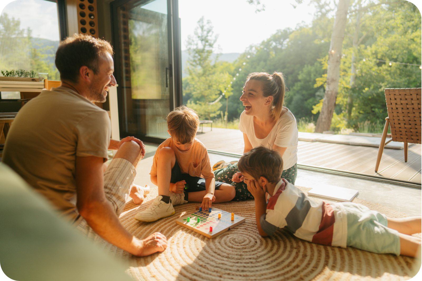 Family of four sitting together playing with toys